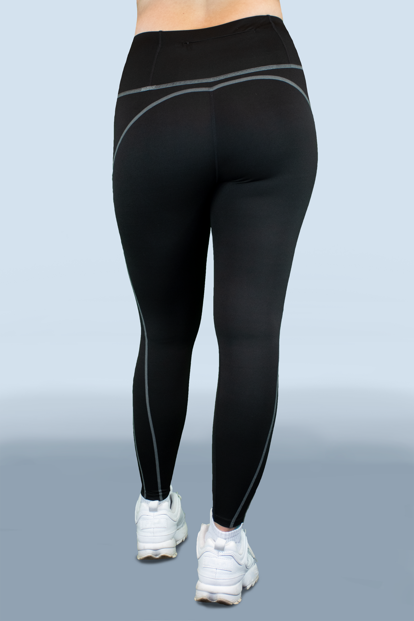 Back view of No Plateau Black Leggings featuring a zip pocket and contrast seams.