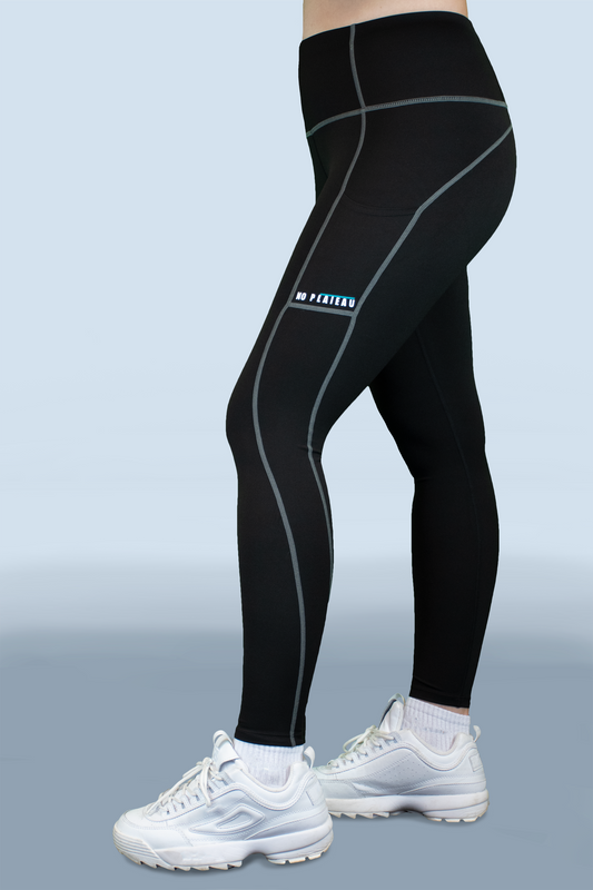 Side view of No Plateau Black Contrast Seam Leggings with shape-enhancing trim.